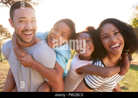 Portrait Of Family Enjoying Walk In Park Together Stock Photo