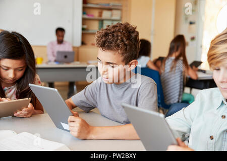 Elementary school kids using tablet computers in class Stock Photo
