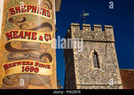 UK, Kent, Canterbury, High Street, The Cricketers pub, Shepherd Neame & Co Brewery sign and tower of St Peter’s Church Stock Photo