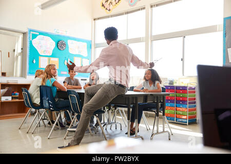 Male teacher with elementary school kids in school class Stock Photo