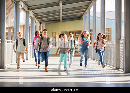 School kids running in elementary school hallway, back view Stock Photo ...