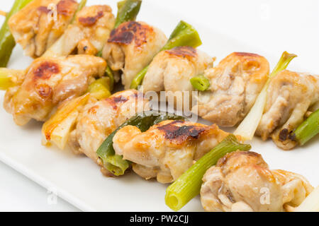 Home cooked Japanese style chicken Yakitori consisting of spring onions and chicken thighs on bamboo skewers and fried with Teriyaki sauce. Dorset Eng Stock Photo