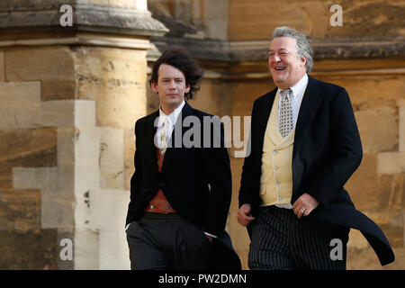 Stephen Fry and husband Elliott Spencer arrive to attend the wedding for the wedding of Princess Eugenie to Jack Brooksbank at St George's Chapel in Windsor Castle. Stock Photo