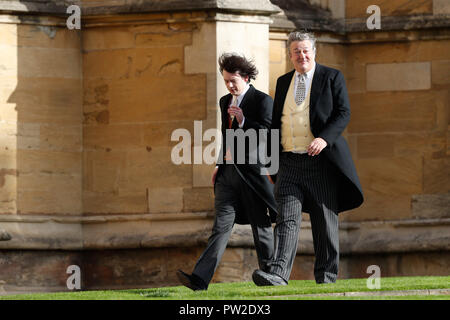 Stephen Fry and husband Elliott Spencer arrive to attend the wedding for the wedding of Princess Eugenie to Jack Brooksbank at St George's Chapel in Windsor Castle. Stock Photo