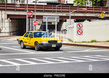 New York City, USA - June 28, 2018: Yellow taxi cab stops at zebra crossing. Stock Photo