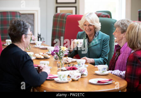 The Duchess of Cornwall, known as the Duchess of Rothesay in Scotland, has morning tea with members of the local community during her visit to the Duke of Rothesay Highland Games Pavilion in Braemar, Aberdeenshire. Stock Photo