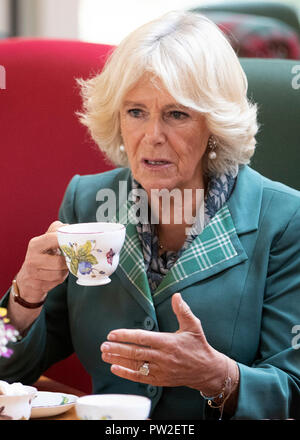The Duchess of Cornwall, known as the Duchess of Rothesay in Scotland, has morning tea with members of the local community during her visit to the Duke of Rothesay Highland Games Pavilion in Braemar, Aberdeenshire. Stock Photo