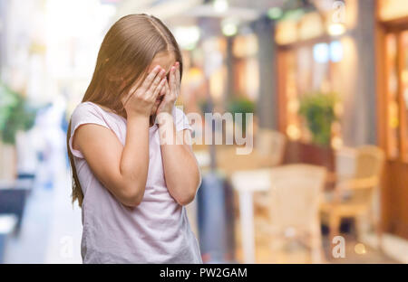 Young beautiful girl over isolated background with sad expression covering face with hands while crying. Depression concept. Stock Photo