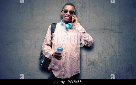 African black man student happy talking using a smartphone mobile phone Stock Photo