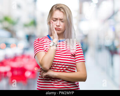 Young blonde woman over isolated background thinking looking tired and bored with depression problems with crossed arms. Stock Photo