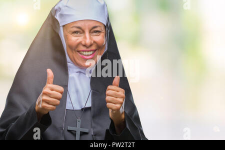 middle-age-senior-christian-catholic-nun-woman-over-isolated-background-approving-doing-positive-gesture-with-hand-thumbs-up-smiling-and-happy-for-su-pw2t2t.jpg