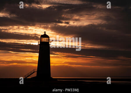 Point of Ayr lighthouse on Talacre beach, North Wales coast at low tide at sunset Stock Photo
