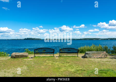 Thousan islands,Canada-august 4,2015:two benches on the banks of the one thousand islands parks in Ontario during a summer day
