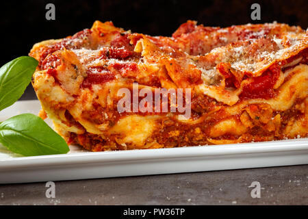 Italian pasta with with bolognese / ragu sauce and bechamel on the white plate - close up view Stock Photo