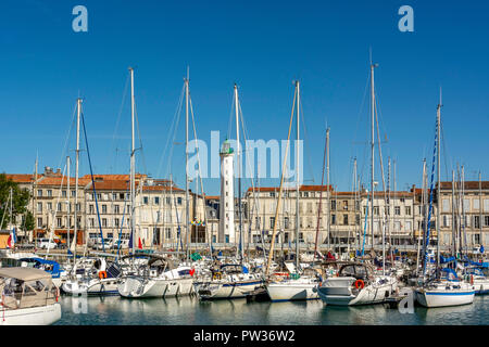 View of the old port of La Rochelle and lighthouse with sailboats and a clear blue sky, Charente-Maritime,  Nouvelle-Aquitaine, France Stock Photo