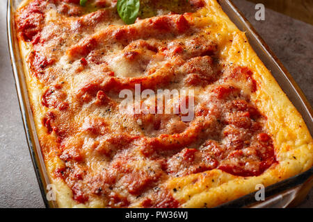 Baked cannelloni stuffed with with bolognese / ragu sauce and bechamel - close up view Stock Photo