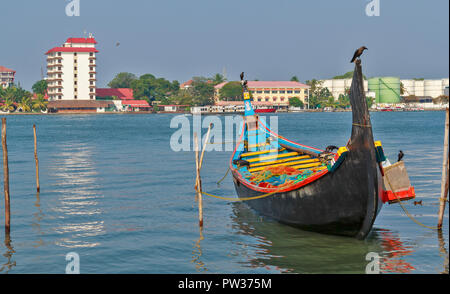 COCHIN KOCHI INDIA THE PORT AND BUILDINGS WITH COLOURFUL TRADITIONAL FISHING BOAT Stock Photo