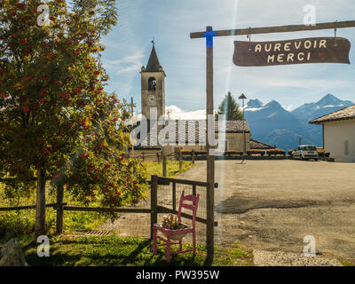 Cafe entrance and a church the village of Lignan in the Aosta Valley Region NW Italy Stock Photo