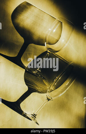 Glass goblets cast beautiful shadow and beautiful caustic effect as light passes through a glass in early morning. Stock Photo