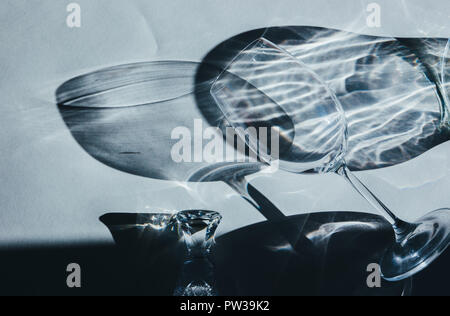 Glass goblets cast beautiful shadow and beautiful caustic effect as light passes through a glass in early morning. Stock Photo