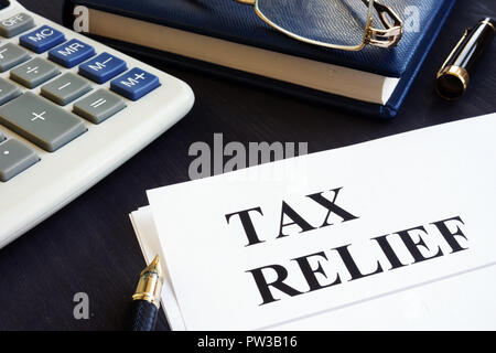 Tax relief concept. Calculator, note pad and pen. Stock Photo