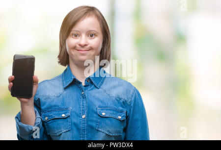 Young adult woman with down syndrome showing smartphone screen over isolated background with a happy face standing and smiling with a confident smile  Stock Photo