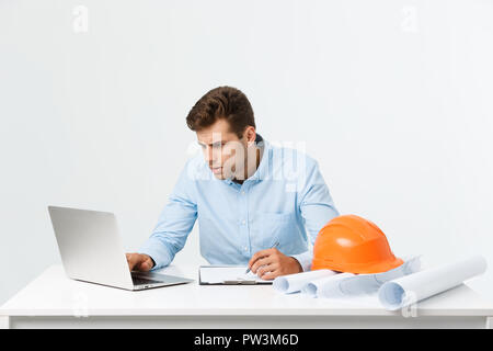 Handsome young man serious working in engineering office. Stock Photo