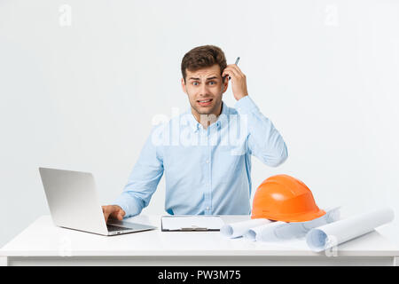 Handsome young man serious working in engineering office. Stock Photo