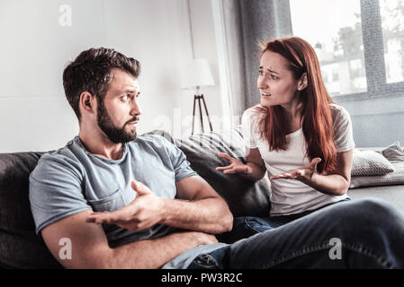 Unhappy cheerless couple having a quarrel Stock Photo