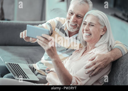 Joyful positive couple taking selfie Stock Photo