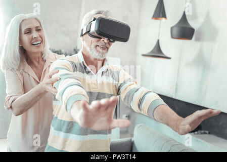 Nice elderly man experiencing virtual reality Stock Photo