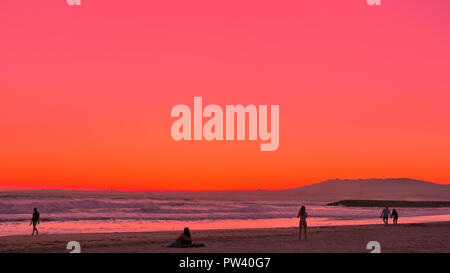 A picturesque pink and orange sunset at a beach in Lisbon Stock Photo