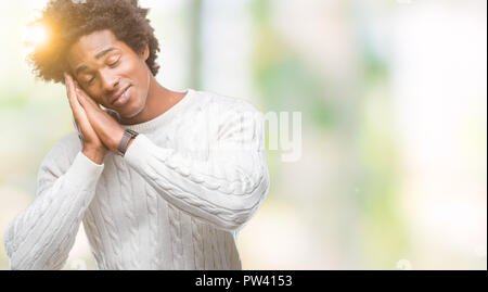 Afro american man over isolated background sleeping tired dreaming and posing with hands together while smiling with closed eyes. Stock Photo