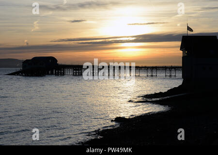 sunrise over mumbles pier and lifeboat station Stock Photo