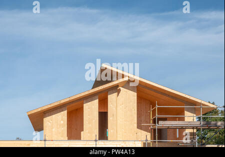 A new house being constructed using modern matarials and building techniques with scaffolding erected for safety. This house is being built inside out Stock Photo