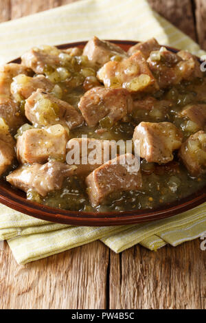 Pork with hot salsa verde closeup on a plate on the table. vertical Stock Photo