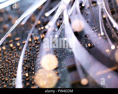 Close-up of illuminated fiber optics on circuit board of laptop computer Stock Photo