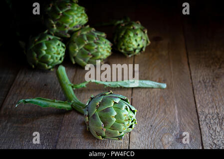 Freshly picked whole globe artichokes. Stock Photo