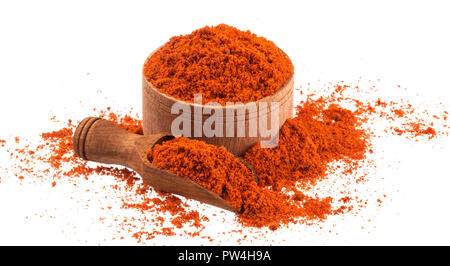 Pile of red paprika powder in wooden bowl and scoop isolated on white background Stock Photo