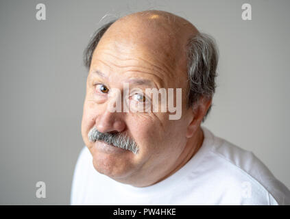 Portrait of older adult senior man in pain with sad and exhausted face in human emotions facial expression retirement and depression concept isolated  Stock Photo
