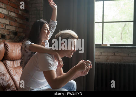 Couple playing video games together at home Stock Photo