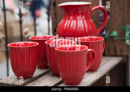 Red porcelain jug and mugs Stock Photo