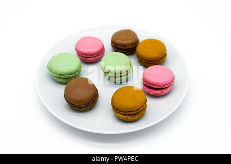 macarons on plate, sweet colorful macarons on white background Stock Photo
