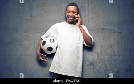 African black m happy talking using a smartphone mobile phone Stock Photo