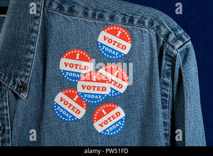 Blue denim working clothing with many Voted stickers on dark background Stock Photo