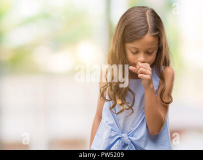 Brunette hispanic girl feeling unwell and coughing as symptom for cold or bronchitis. Healthcare concept. Stock Photo