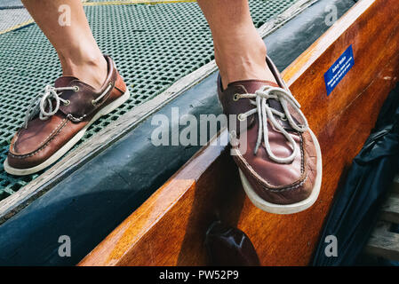 Boat shoes of our punting tour guide and professional punter in the pier in Cambridge, UK Stock Photo