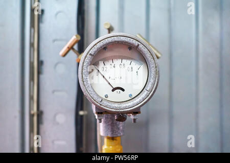 Manometer showing zero mounted on gas pipe colored yellow. Stock Photo