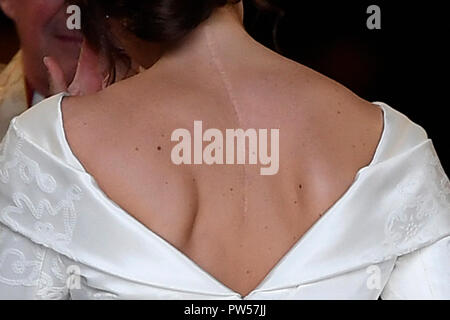 Princess Eugenie, with the scar from her surgery for scoliosis to treat a curvature of the spine at the age of 12 visible, as she enters St George's Chapel for her wedding to Jack Brooksbank in Windsor Castle, Windsor. Stock Photo