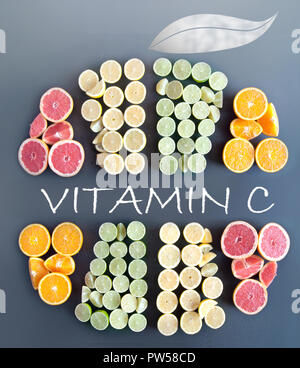 Many citrus fruits in the shape of a sliced fruit icon with handwritten vitamin c on a chalkboard Stock Photo